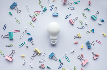 Lightbulb with set of colorful paper clips on white background.business creativity concept.Flat lay design.