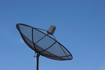 Black satellite dish, sky background
