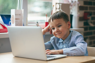 Boy focused on laptop