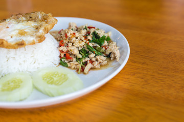 Rice topped with stir-fried pork and basil with fried egg
