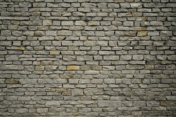 Large grey brick wall in the city