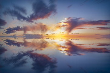 sky, dramatic sunset with colorful clouds and the reflection of the sky in the water