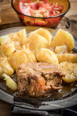 Stewed pork meat served with potatoes