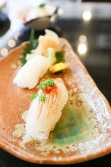 Engawa sushi and coriander topping on dish