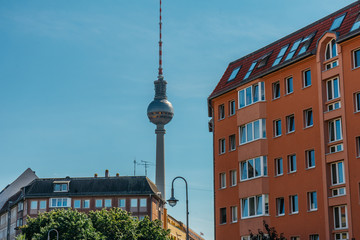 tv-tower in the heart of berlin framed by old apartment houses
