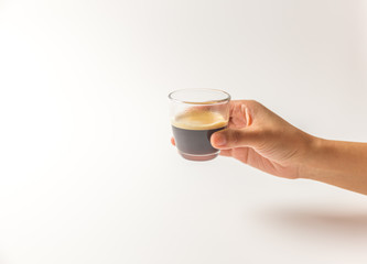 hand holding a glass of expresso coffee with white blackground copy space, clipping paths