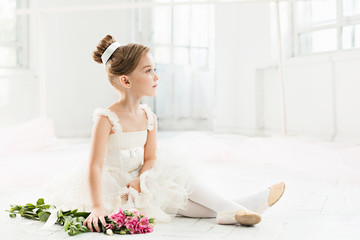 The little balerina in white tutu in class at the ballet school © master1305