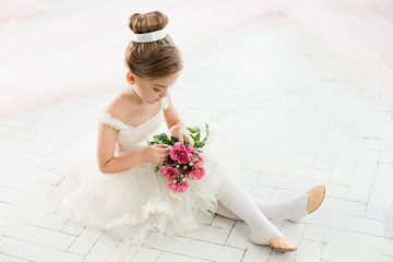 The little balerina in white tutu in class at the ballet school © master1305