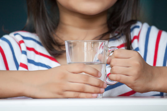 Girl holding a glass of water