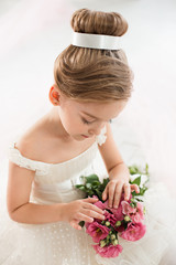 The little balerina in white tutu in class at the ballet school © master1305