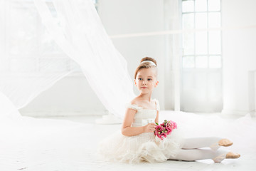 The little balerina in white tutu in class at the ballet school © master1305