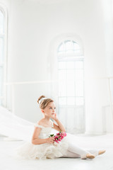 The little balerina in white tutu in class at the ballet school © master1305