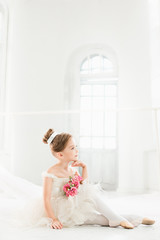 The little balerina in white tutu in class at the ballet school © master1305