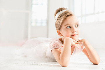 The little balerina in white tutu in class at the ballet school © master1305