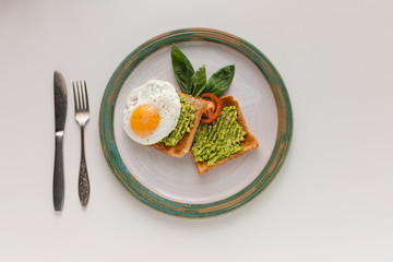 fried egg and avocado on toasts
