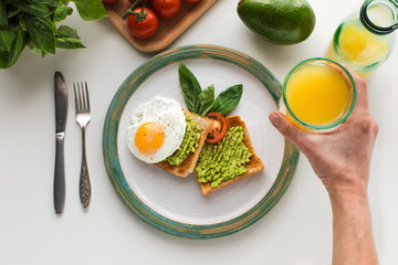 fried egg and mashed avocado on toasts
