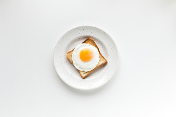 top view of breakfast with fried egg on toast, isolated on white