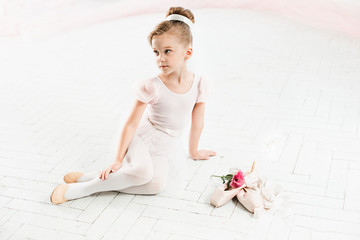 The little balerina in white tutu in class at the ballet school © master1305