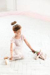 The little balerina in white tutu in class at the ballet school © master1305