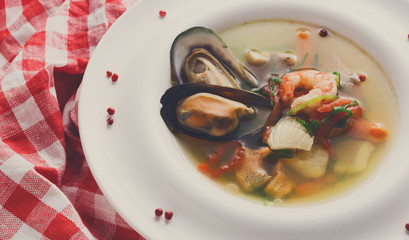 French seafood soup with white fish, shrimps and mussels in plat