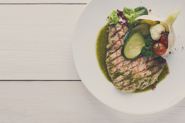 Grilled beefsteak with vegetables and green bell pepper sauce