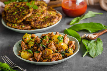 Potato pancakes, fried chicken with potatoes