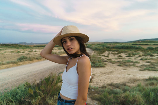 Woman posing with hat in nature