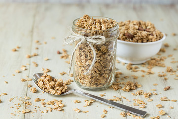 Almond Granola In Glass Jar and Bowl With Spoon