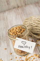 Almond Granola With Heart Healthy Tag On Glass Jar Vertical
