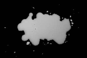 Milk splashes isolated on black background, top view,  clipping path