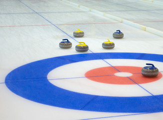 Curling stones equipment on the ice - obrazy, fototapety, plakaty