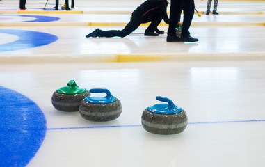 Curling stones equipment on the ice
