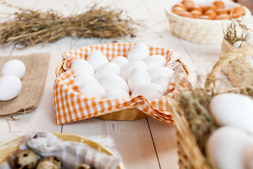Fototapeta na wymiar Chicken eggs in basket on wooden background