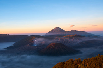 Fototapeta na wymiar Mount Bromo volcano during sunrise, the magnificent view of Mt.Bromo located in Bromo Tengger Semeru National Park, East Java, Indonesia, Kingkong Hill viewpoint, Penajakan 