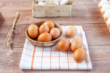 Close-up view of raw chicken eggs on wooden background