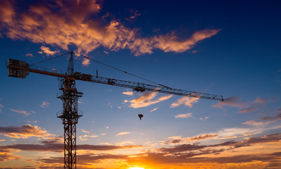 Fototapeta premium Silhouette crane construction site on sunset time