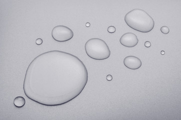 water drops with reflection on pixel textured background, black & white photography