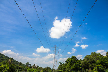Obraz premium High voltage electric tower on the mountain and blue sky background.