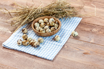 Quail eggs on the old rustic wooden table.