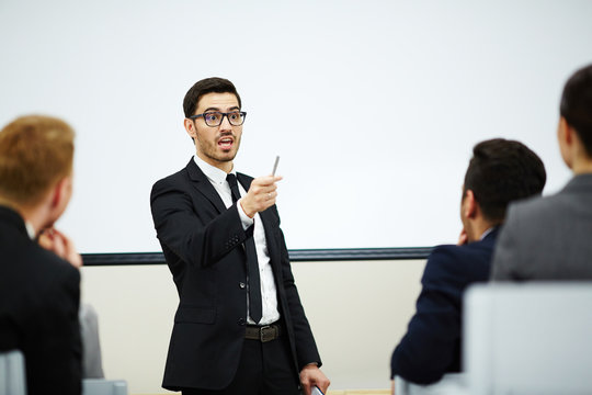 Business Conference At Full Speed: Enthusiastic Bearded Speaker Communicating With Audience While Making Presentation