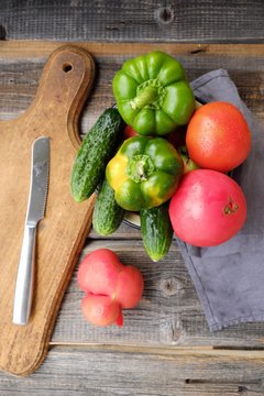 Fresh tasty vegetables on wooden background view 