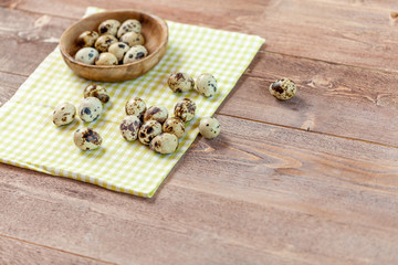 Quail eggs on the old rustic wooden table.