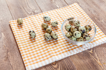 Quail eggs on the old rustic wooden table.