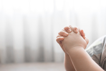 Little boy praying in the morning.Little asian boy hand praying,Hands folded in prayer concept for faith,spirituality and religion.