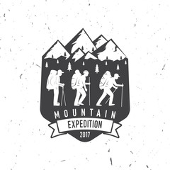 Vintage typography design with mountaineers and mountain silhouette.