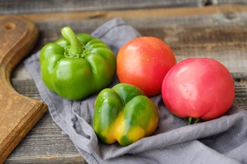 Fresh tasty vegetables on wooden background view 