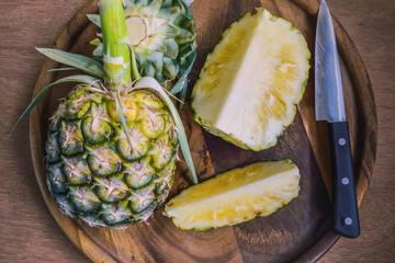 Fresh pineapple on wood plate
