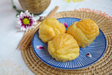 Homemade eclair on a plate served with tea or coffee 