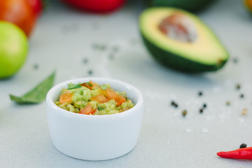 Traditional mexican avocado - vegetarian dip surrounded by its ingredients.