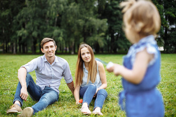 Young happy family in summer Park